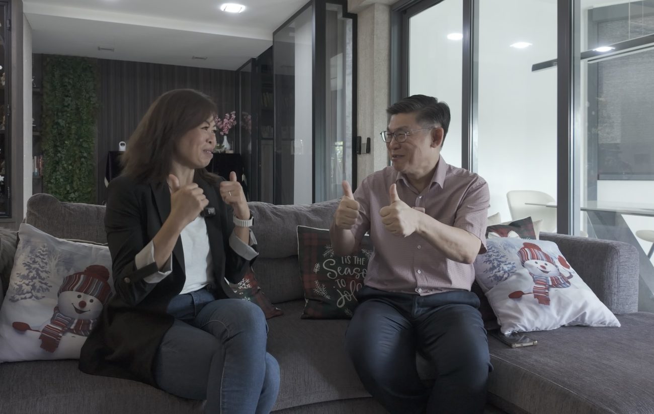 Esther Ng celebrating a completed purchase with clients in their new home